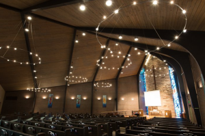 The United Church of Christ is illuminated by 40 wall sconces, 80 canned ceiling lights and 120 bulbs in wagon wheel chandeliers.