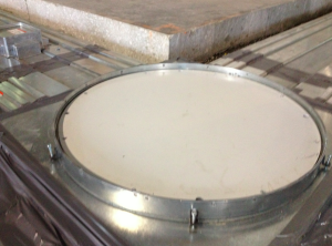 A round junction box in the cut-out trench connects two segments of the Walkercell system. A “preset,” visible to the left, will channel wires and cables to a workstation once the project is finished and the duct system is covered with new concrete.