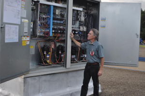 Senior Energy Engineer Gary Jacobs, CEM, looks over Robison Elementary’s RTU controls.