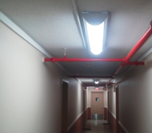 About 424 Voyager LED bi-level fixtures from LaMar Lighting replaced existing surface-mounted hallway lighting at Fresh Pond Apartments.