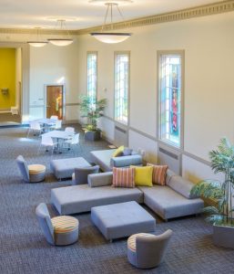 TAT embraced the vibrant colors of the community room's large stained-glass windows and reflected them in the space's finishes and furnishings.