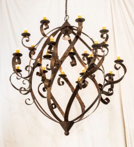 The Caliope Chandelier is 80 inches wide and adorned with 24 Amber faux candlelights.