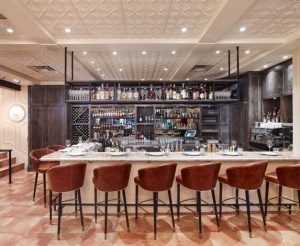 Decorative ceiling panels over this bar, the main dining area, the antipasto bar and beyond, help to unify the space. 