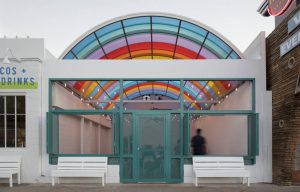 A translucent vaulted canopy crowns the outdoor dining area in a swirl of colors.